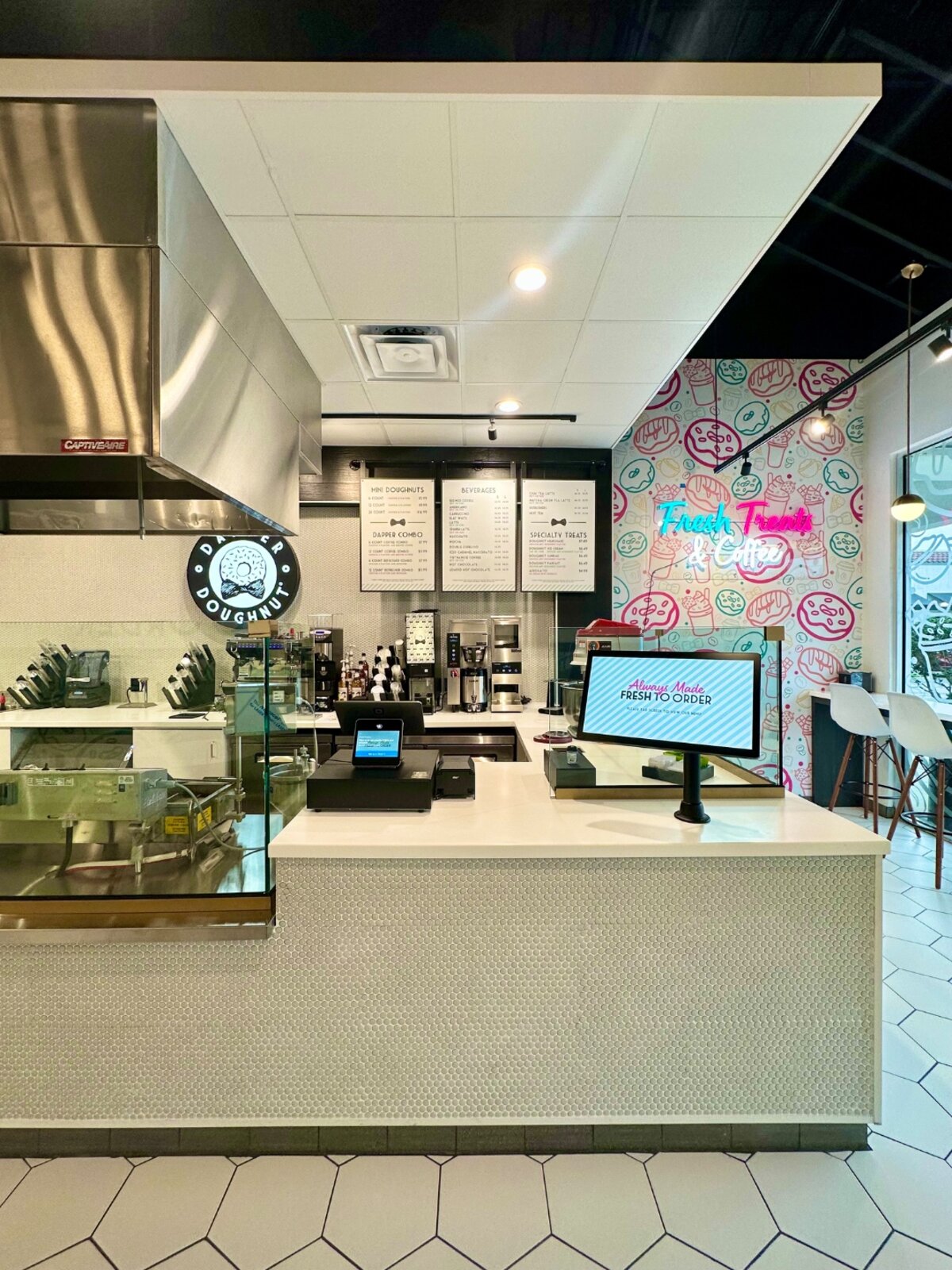 Dapper Doughnut store interior with service counter, menu boards and doughnut wall graphics
